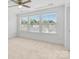 Bedroom features large windows for natural light, a ceiling fan, and neutral carpet at 3153 Bending Birch Pl, Charlotte, NC 28206