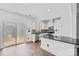 Modern white kitchen featuring stainless steel appliances, a granite countertop, and ample cabinet space at 3153 Bending Birch Pl, Charlotte, NC 28206