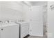 Functional laundry room with a washer, dryer, and shelving for storage at 3153 Bending Birch Pl, Charlotte, NC 28206