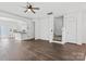 Bright living room with hardwood floors, ceiling fan, and an open floor plan to the kitchen at 3153 Bending Birch Pl, Charlotte, NC 28206