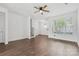 Sun-lit living room with hardwood floors and a large window overlooking the front yard at 3153 Bending Birch Pl, Charlotte, NC 28206
