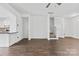 Open floor plan living room with hardwood floors and stairway access at 3153 Bending Birch Pl, Charlotte, NC 28206