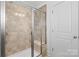Bathroom with tiled shower that includes a glass door and a built-in seat at 3153 Bending Birch Pl, Charlotte, NC 28206