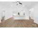 Bright kitchen open to living room with hardwood floors, white walls, and white cabinets at 338 Hollingswood Dr, Statesville, NC 28625