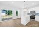Bright kitchen featuring stainless steel appliances, white cabinets, and a sliding glass door at 338 Hollingswood Dr, Statesville, NC 28625