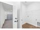 Convenient laundry room offers hookups and shelving, adjacent to a spacious garage at 338 Hollingswood Dr, Statesville, NC 28625