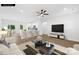 Bright living room open to kitchen, with hardwood floors, white walls, and ample natural light at 338 Hollingswood Dr, Statesville, NC 28625
