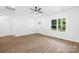 Room with hardwood floors, ceiling fan, one window, and a white door at 338 Hollingswood Dr, Statesville, NC 28625