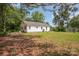 Exterior view of home showcasing lush backyard with mature trees on a clear day at 3595 Mt Holly Rd, Edgemoor, SC 29712
