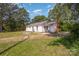 The exterior of the home is surrounded by an expansive yard with a lush backdrop of trees at 3595 Mt Holly Rd, Edgemoor, SC 29712