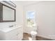 Bright bathroom features a modern vanity, woodgrain floors and a window providing natural light at 3595 Mt Holly Rd, Edgemoor, SC 29712