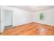 A large, bright bedroom featuring hardwood floors, white walls, and natural light at 3595 Mt Holly Rd, Edgemoor, SC 29712