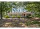 Charming single-story home with a well-maintained front yard and mature trees offering ample shade at 3595 Mt Holly Rd, Edgemoor, SC 29712