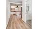 Hallway view into updated kitchen, featuring an island, open shelving and stainless appliances at 3595 Mt Holly Rd, Edgemoor, SC 29712