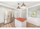 Open concept kitchen with butcher block island, stainless steel refrigerator, and hardwood style floors at 3595 Mt Holly Rd, Edgemoor, SC 29712