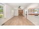 Inviting living room with a brick fireplace, ceiling fan, and view into the updated kitchen space at 3595 Mt Holly Rd, Edgemoor, SC 29712