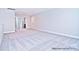 Spacious carpeted bedroom with neutral walls and natural light creating a relaxing and comfortable atmosphere at 4178 Millstream Rd, Denver, NC 28037