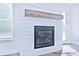 Elegant fireplace with a wooden beam mantle and shiplap detailing at 4178 Millstream Rd, Denver, NC 28037