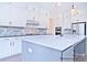 Bright kitchen with white cabinets, stainless steel appliances, and gray backsplash tiles at 4178 Millstream Rd, Denver, NC 28037
