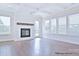 Cozy living room with a white fireplace and large windows for natural light at 4178 Millstream Rd, Denver, NC 28037
