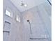 This shower showcases beautiful tile work, two windows, and a rain shower head at 4178 Millstream Rd, Denver, NC 28037