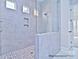 This is a shower featuring beautiful tile work, a rain shower head, and tiled shower niches at 4178 Millstream Rd, Denver, NC 28037