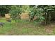 Backyard featuring a swing set, wooded area, and a wooden privacy fence at 4227 Kiser Woods Sw Dr, Concord, NC 28025