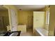 Bathroom with a bathtub and a separate shower stall with yellow walls at 4227 Kiser Woods Sw Dr, Concord, NC 28025