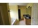 Bright bathroom featuring a double vanity, bath tub, and light fixtures at 4227 Kiser Woods Sw Dr, Concord, NC 28025