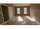 Bedroom featuring two windows offering plenty of natural light and an unfinished floor at 4227 Kiser Woods Sw Dr, Concord, NC 28025