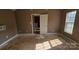 Bedroom featuring hardwood floors, a light fixture, and a view into an adjacent room at 4227 Kiser Woods Sw Dr, Concord, NC 28025