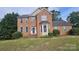 Traditional brick home with a well-manicured lawn, neutral shutters and a bay window adds curb appeal at 4227 Kiser Woods Sw Dr, Concord, NC 28025