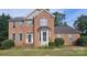 Charming two-story brick home with a bay window, gray shutters, and a well-maintained front yard at 4227 Kiser Woods Sw Dr, Concord, NC 28025