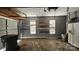 Spacious garage featuring a garage door, storage shelves, and a refrigerator at 4227 Kiser Woods Sw Dr, Concord, NC 28025