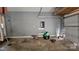 A spacious garage featuring a concrete floor, gray walls, and ample storage space at 4227 Kiser Woods Sw Dr, Concord, NC 28025