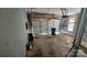 A spacious garage featuring an open door, concrete floor, gray walls, and storage at 4227 Kiser Woods Sw Dr, Concord, NC 28025