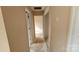 Hallway view with open doorways and neutral-toned walls leading to various rooms in the home at 4227 Kiser Woods Sw Dr, Concord, NC 28025