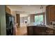 Open-concept kitchen featuring a dishwasher, a sink, and hardwood floors at 4227 Kiser Woods Sw Dr, Concord, NC 28025