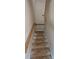 Interior stairway showcasing wooden railing and steps leading upwards to the next level at 4227 Kiser Woods Sw Dr, Concord, NC 28025