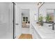 Bathroom featuring double sinks, a large mirror and a doorway into the main bedroom at 428 Clay St, Mooresville, NC 28115