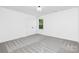 This bedroom has gray carpet, double door closet, and a window at 428 Clay St, Mooresville, NC 28115