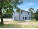 Two-story home featuring a light-gray exterior, large garage, sliding glass door, and a spacious backyard at 428 Clay St, Mooresville, NC 28115