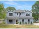 Charming two-story home with blue siding, manicured lawn, and black trim windows at 428 Clay St, Mooresville, NC 28115