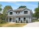Two-story home boasts light blue siding, white trim, a garage, and a cozy front porch at 428 Clay St, Mooresville, NC 28115
