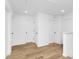 Upstairs hallway with several doors and wood-look flooring at 428 Clay St, Mooresville, NC 28115