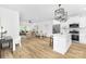 Bright kitchen featuring a white island, stainless steel appliances, and an open layout into the living area at 428 Clay St, Mooresville, NC 28115