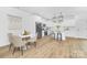 Bright kitchen features white cabinetry, modern appliances, a dining nook, and pendant lighting at 428 Clay St, Mooresville, NC 28115