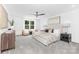 Bright main bedroom featuring neutral decor, carpeted floors, and a ceiling fan at 428 Clay St, Mooresville, NC 28115