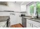 Bright kitchen with granite countertops, stainless appliances, and natural light from the window at 433 W 8Th St # 66, Charlotte, NC 28202