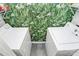 Practical laundry room with washer, dryer, and vibrant leaf patterned wallpaper at 433 W 8Th St # 66, Charlotte, NC 28202